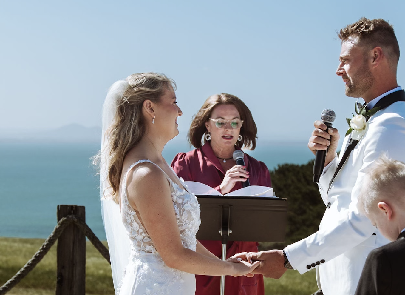 A couple smiling during their wedding ceremony